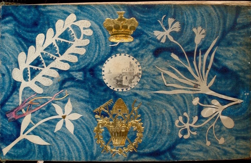 A rectangular patterned surface with floral motifs, a crown, a building, and a crest.