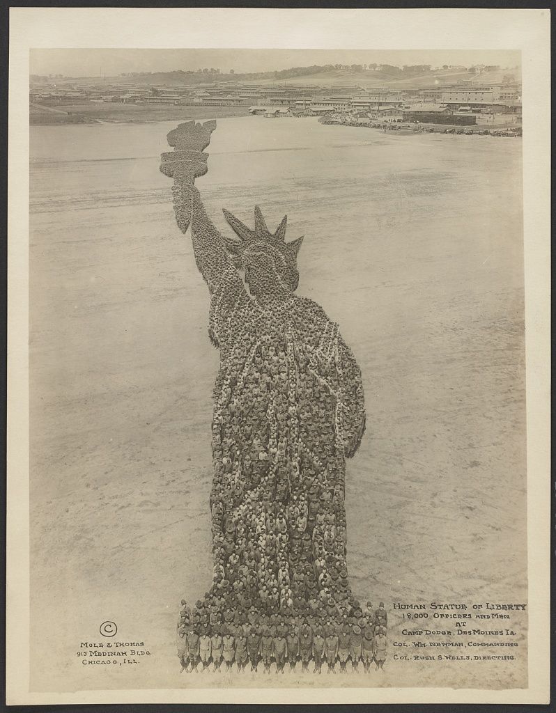 A vintage photograph of a human formation recreating the Statue of Liberty with 9,000 officers and men at Camp Dodge, Des Moines, IA.