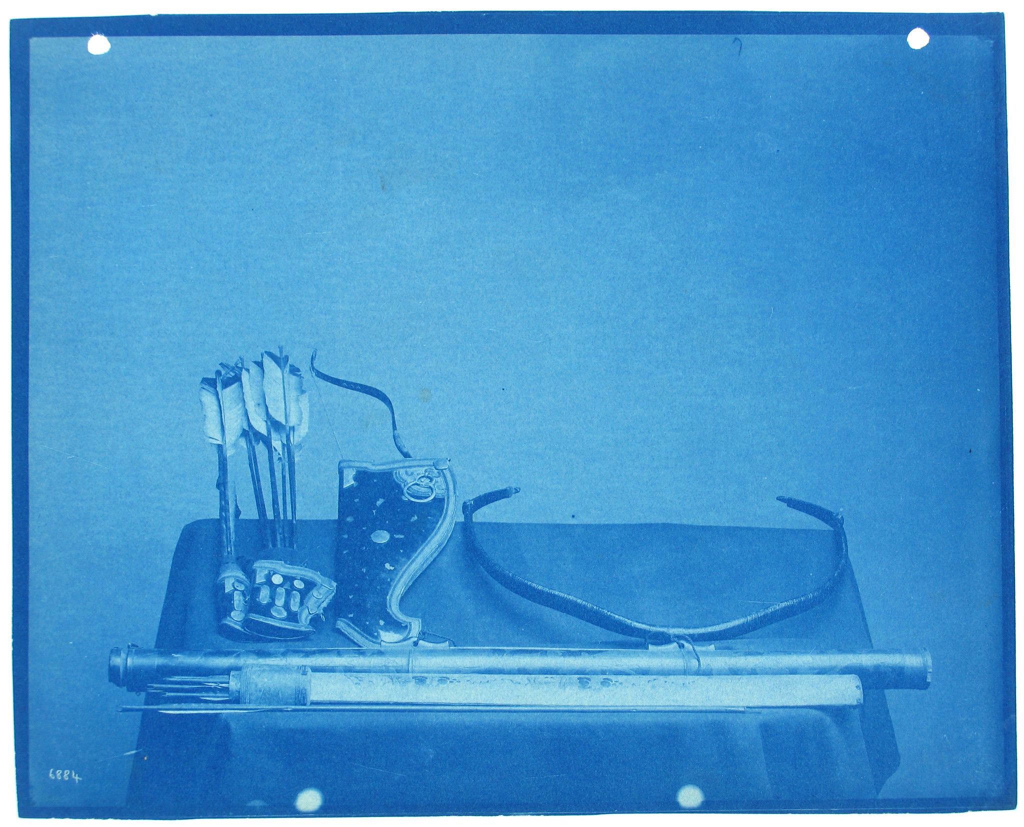 Cyanotype photograph of a bow and arrows.