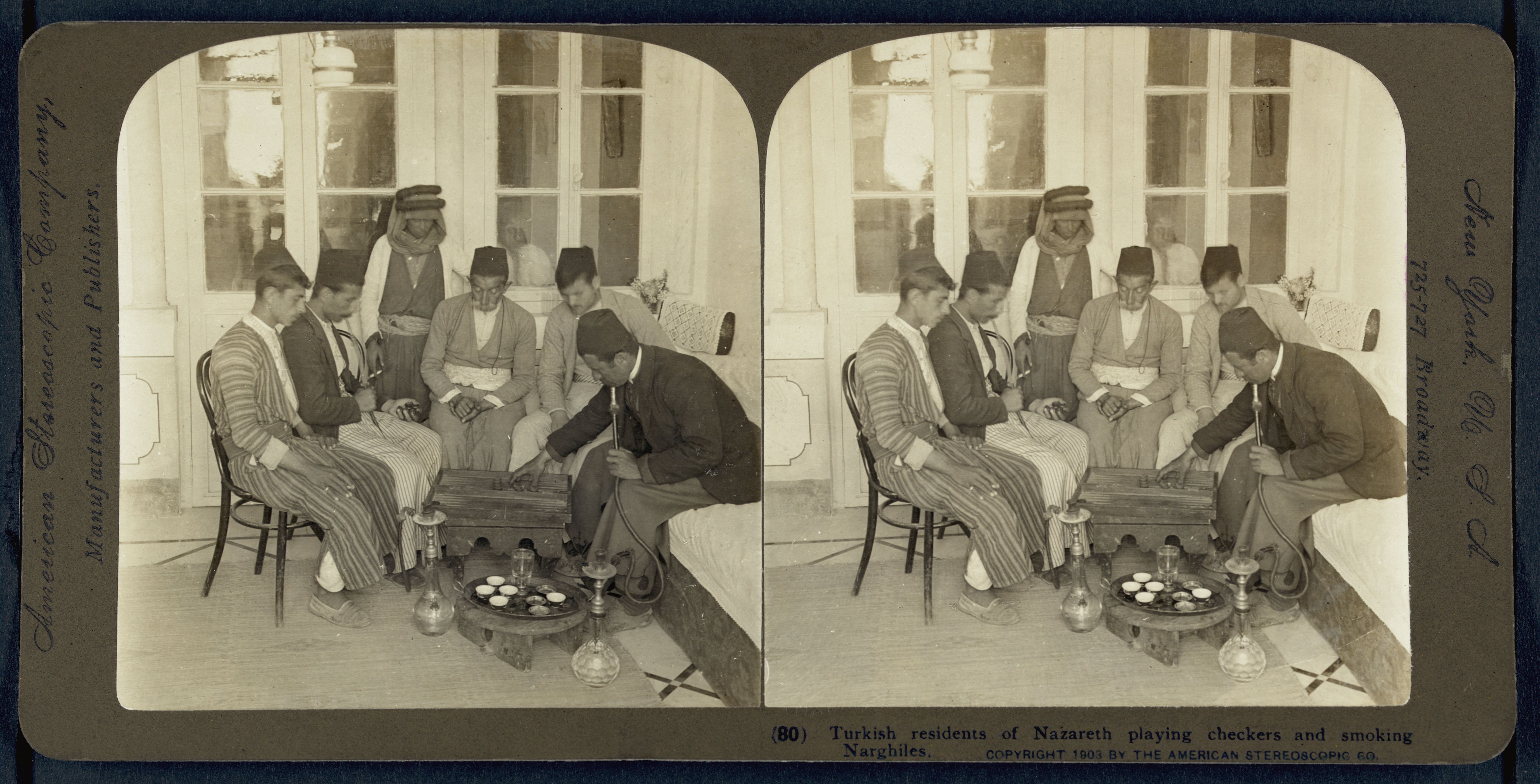 Stereoscopic photograph of Turkish residents of Nazareth playing checkers and smoking nargiles in 1901.