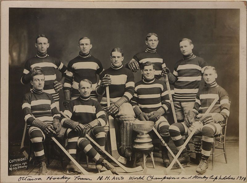 A vintage black and white photograph of the Ottawa Hockey Team, identified as N.H. Association World Champions and Stanley Cup holders in 1911.