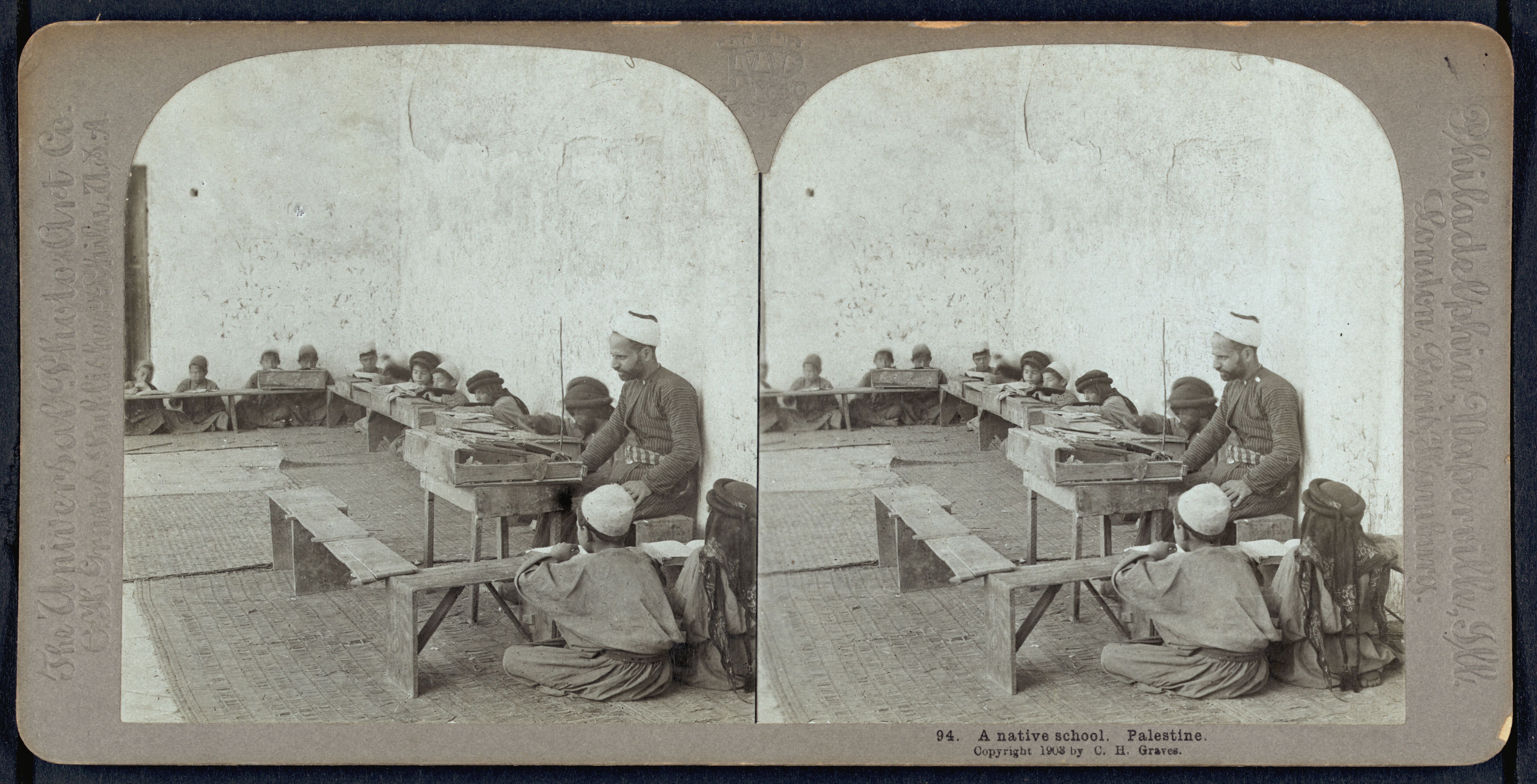 Stereoscope card of a native school in Palestine, 1898. A classroom with students and a teacher.