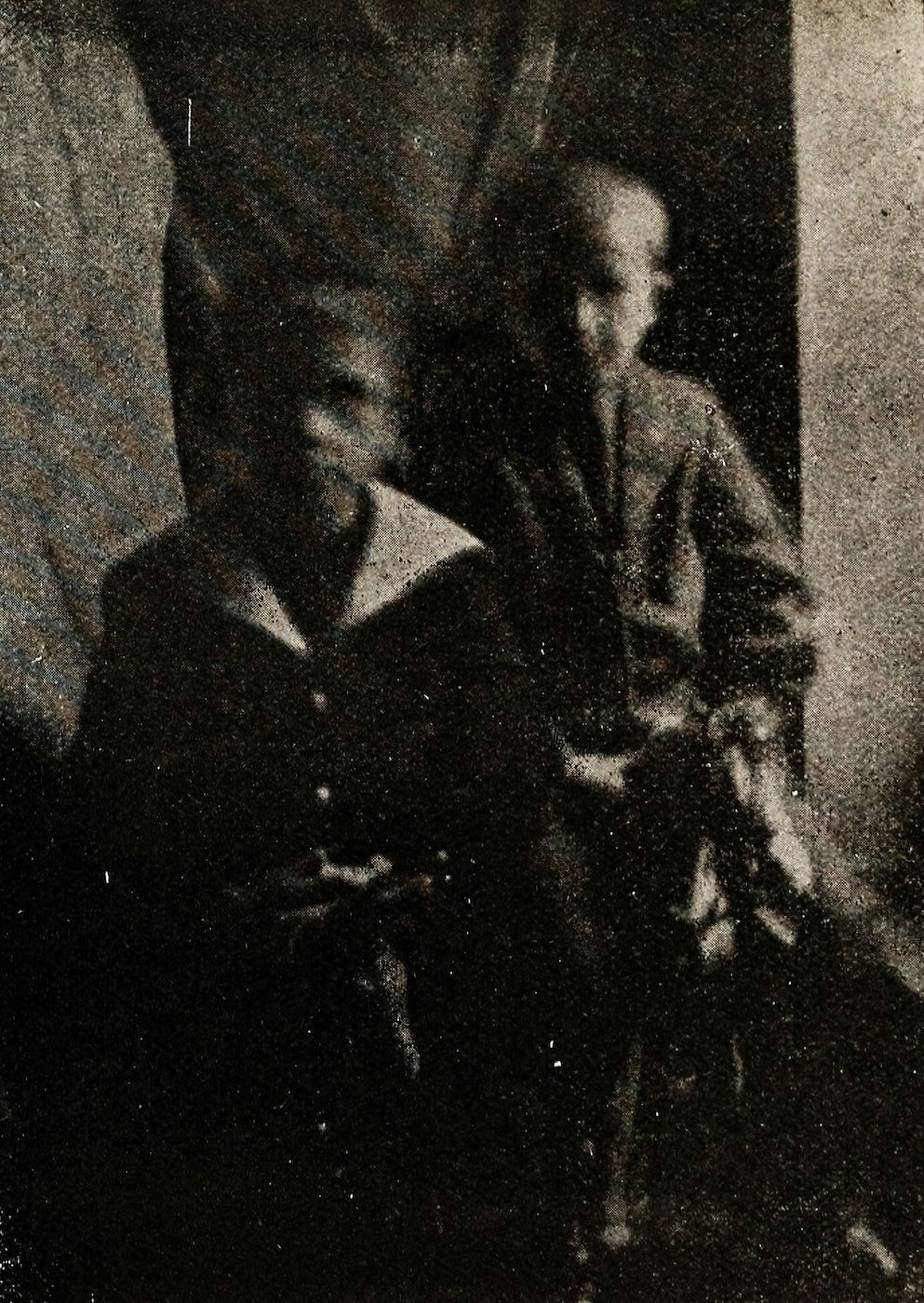 A grainy black and white photograph of two men in military uniforms.