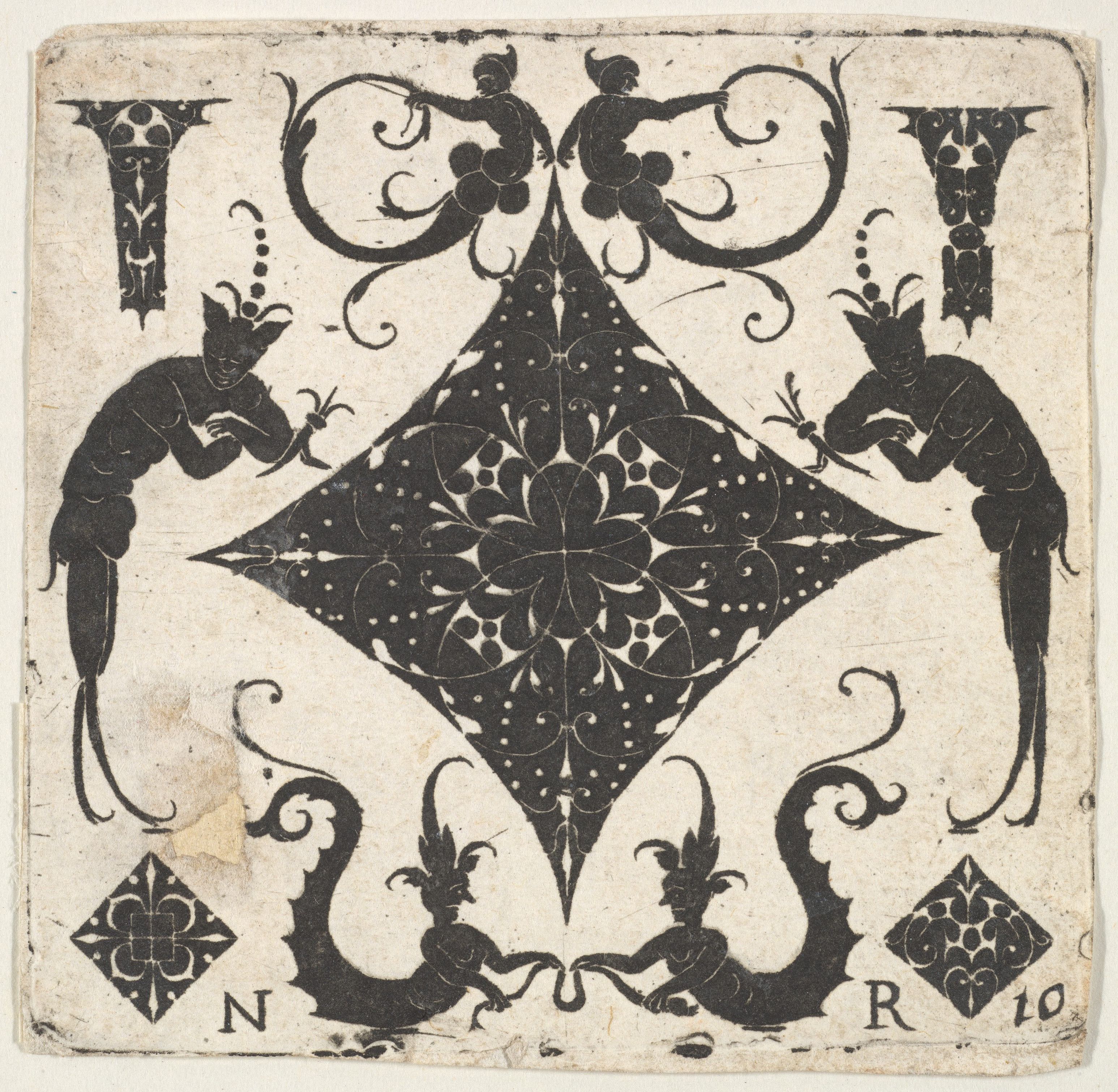 Vintage playing card with ornate black and beige design.
