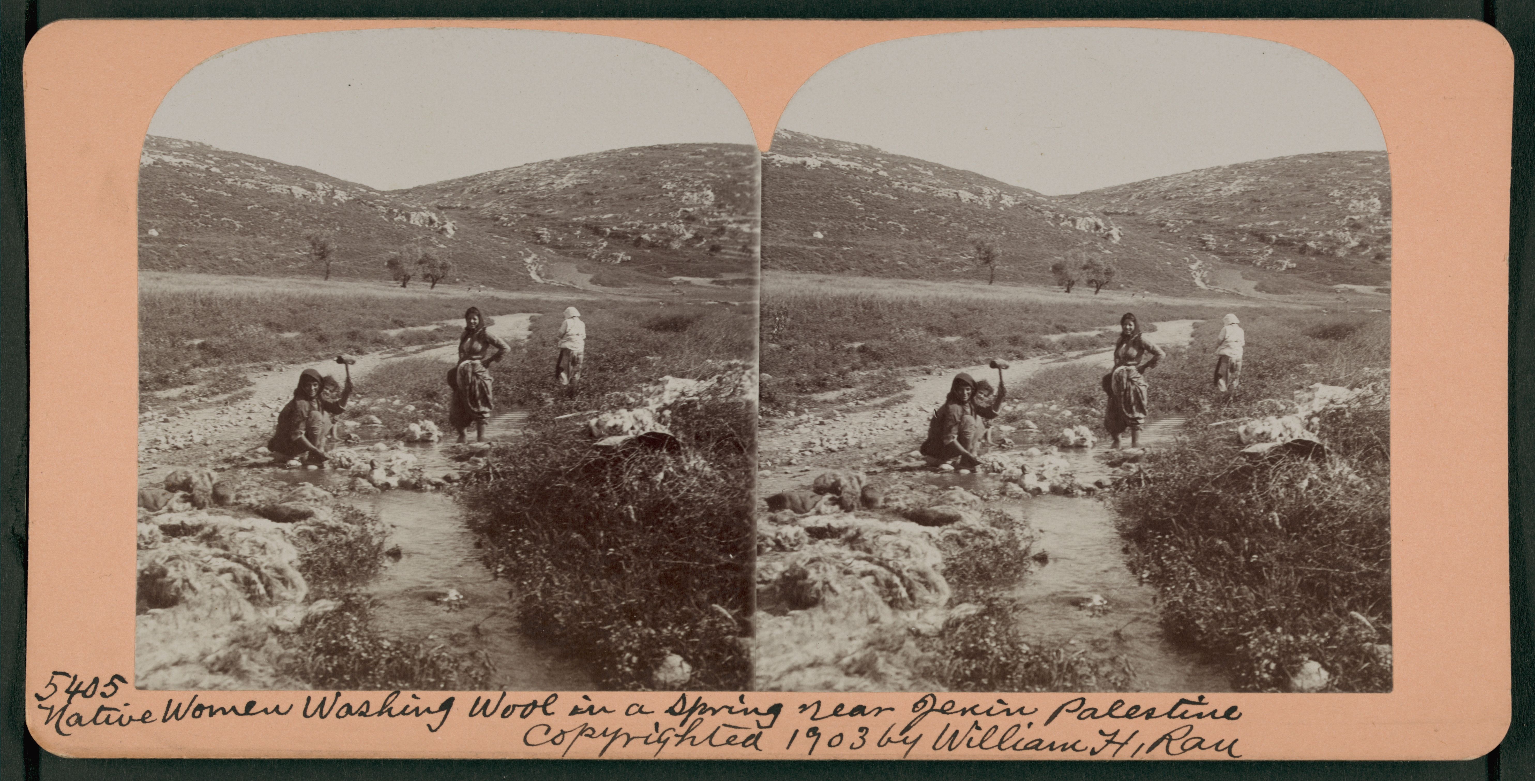 Stereoscopic photograph of two women washing wool in a spring near Jenin, Palestine, 1903.