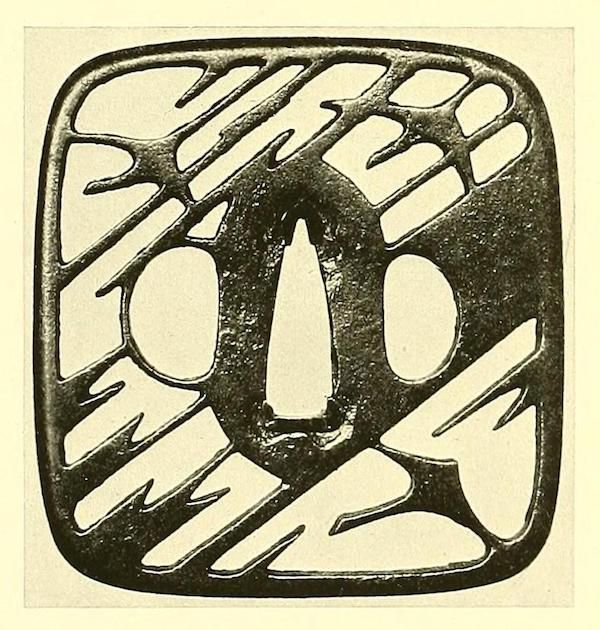A dark, intricately carved glyph or symbol on a light background.