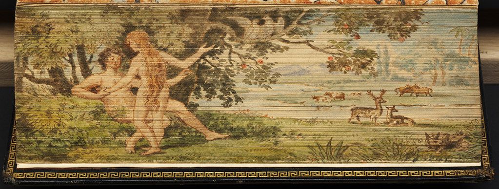 A rectangular tapestry depicting a nude woman reaching for fruit on a tree in a lush landscape with deer.