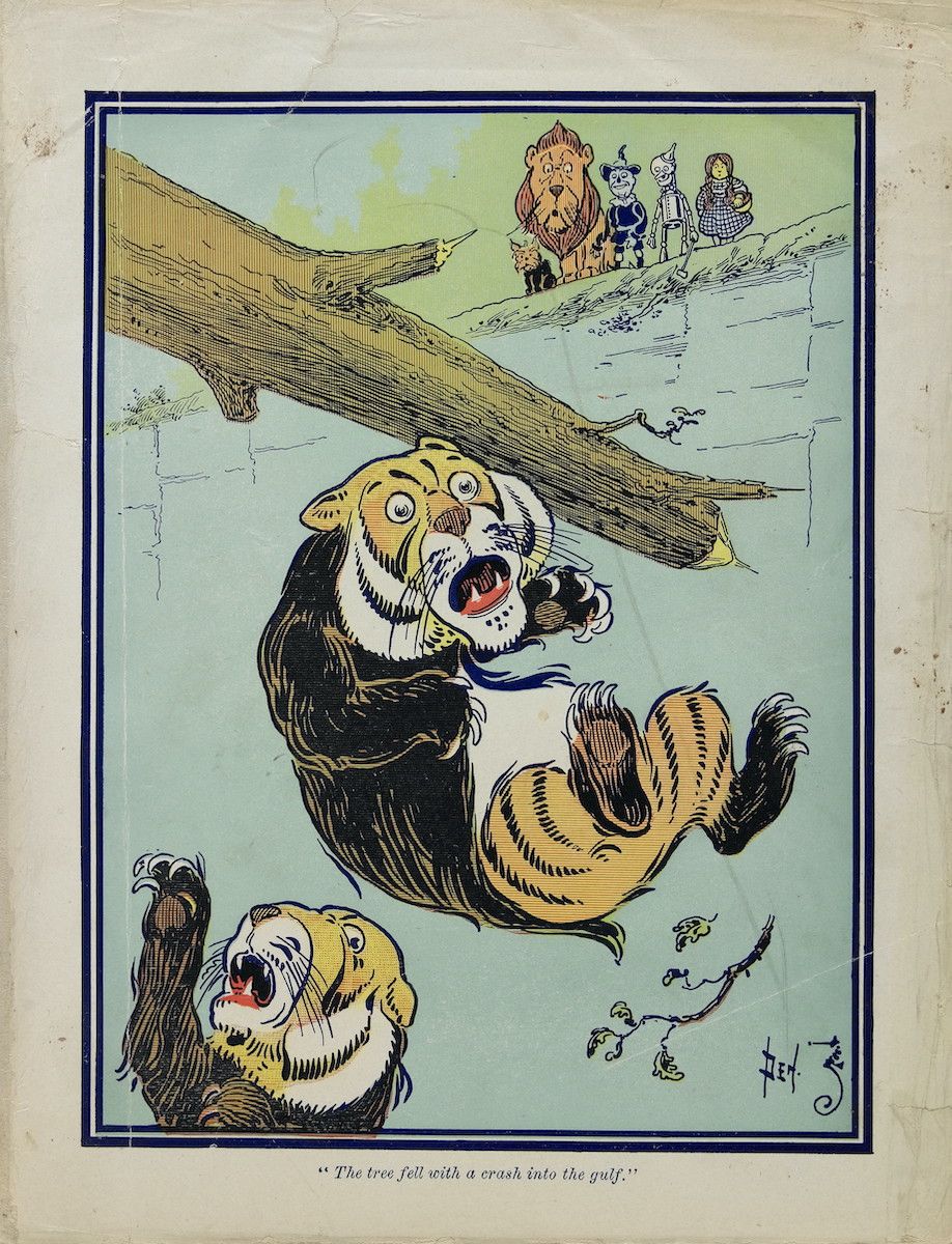 Vintage illustration of a tiger falling off a tree branch with Dorothy, the Scarecrow, the Tin Woodman, and the Lion looking down in alarm. Caption reads: "The tree fell with a crash into the gulf."