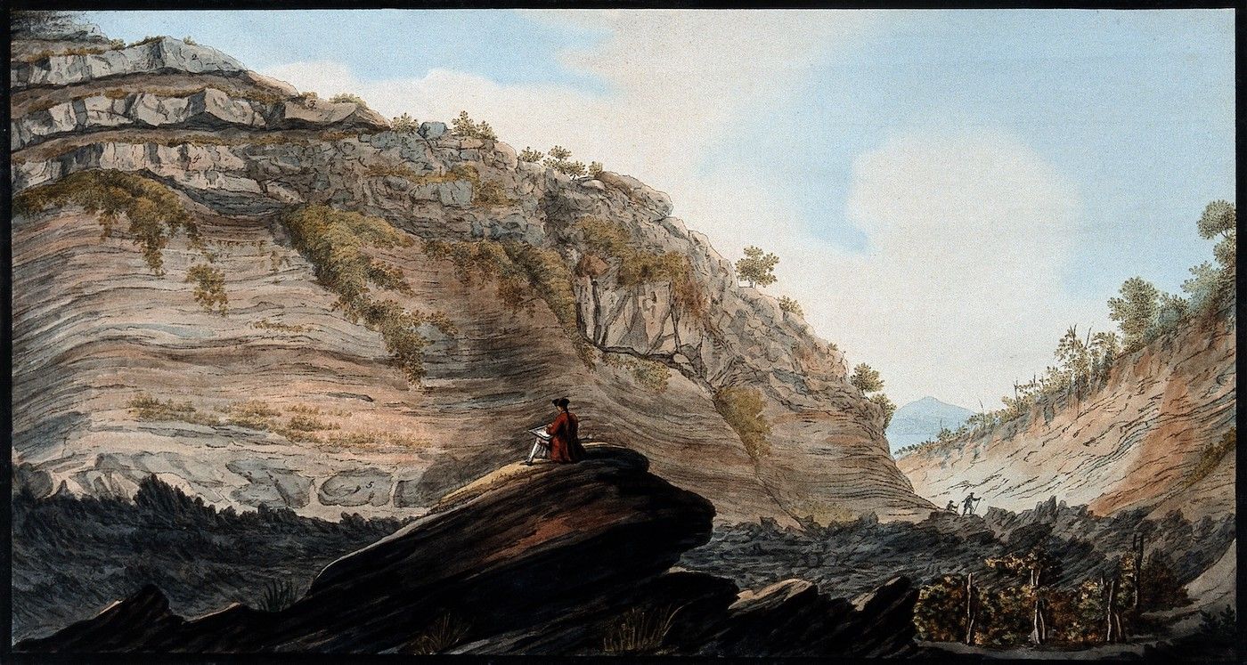 Watercolor painting of a rugged mountain landscape with a figure sketching on a rock.