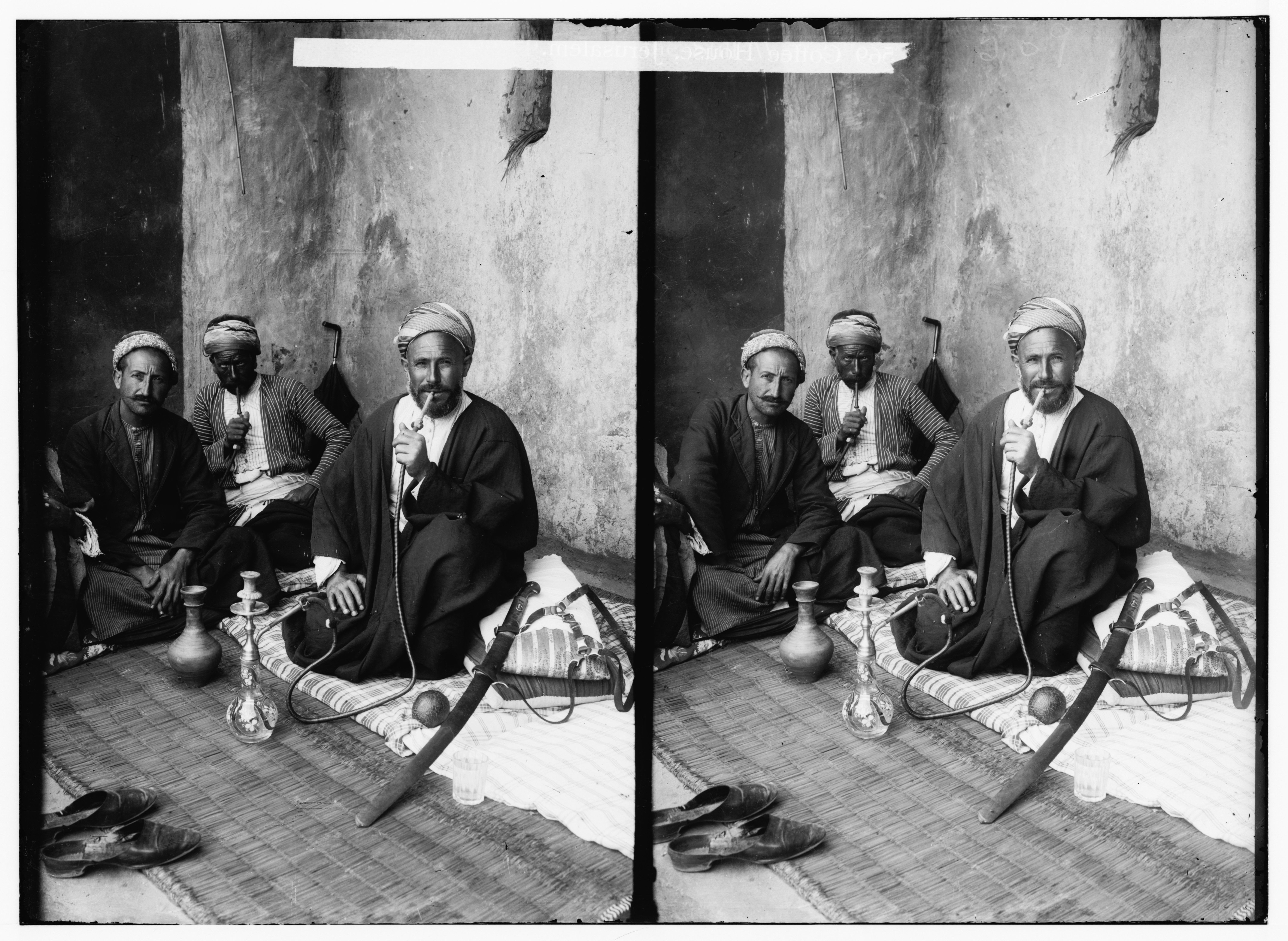 Stereoscopic photograph of three men smoking hookahs in a room.