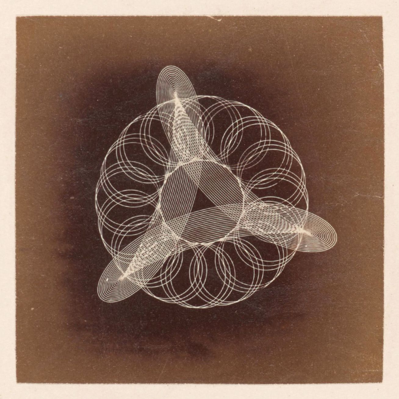 Vintage sepia-toned photograph of a complex geometric pattern of circles and lines.