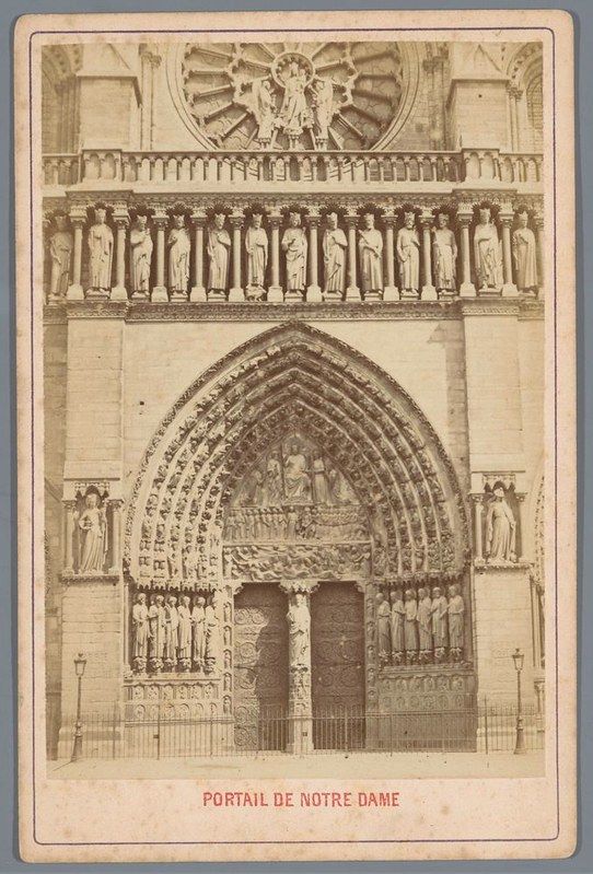 A vintage black and white photograph of the portal of Notre Dame Cathedral.