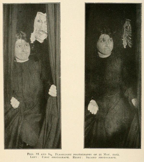 Two black and white photographs side-by-side, labeled as 'Flashlight Photographs of 21 May, 1912'. The left image is the 'First Photograph' and the right is the 'Second Photograph'. Both photographs depict the same two individuals, a woman and a man, standing close together and draped in dark fabric.