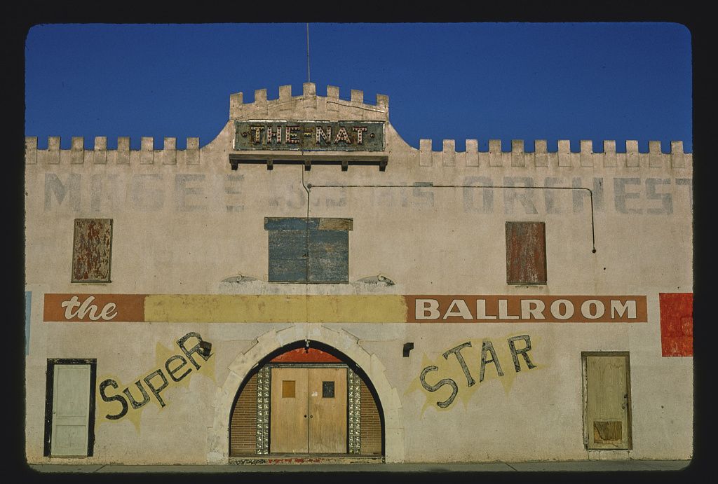 A weathered, vintage building with a distinctive, castle-like facade and faded signs for "Super" and "Star Ballroom".