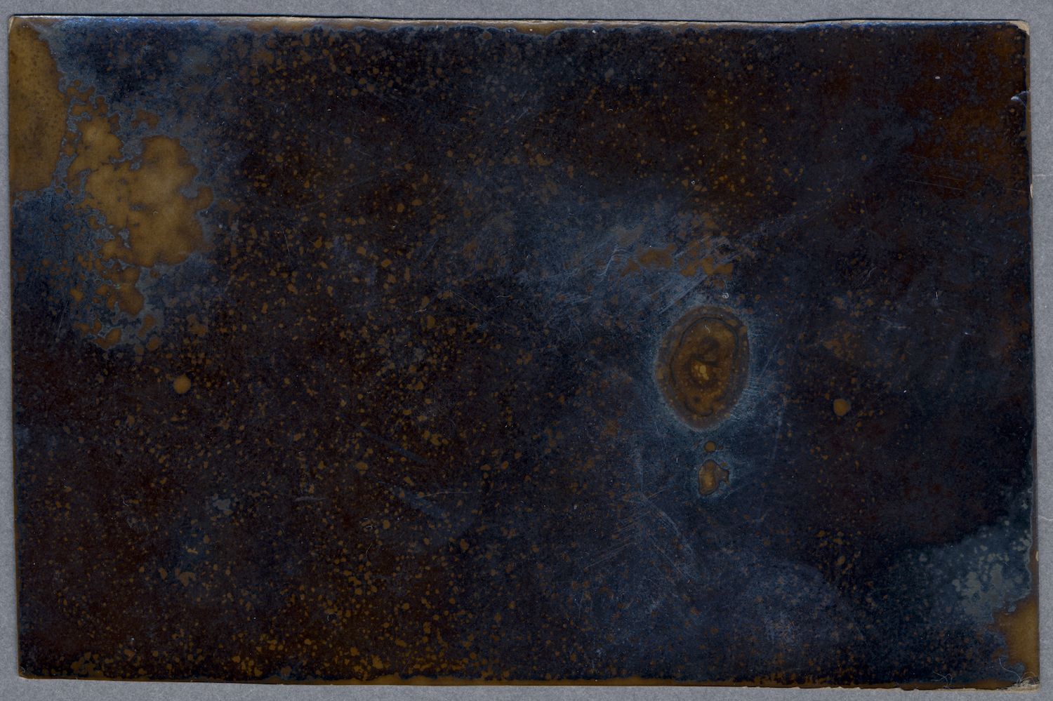 Close-up of a dark, textured surface with a swirling pattern.