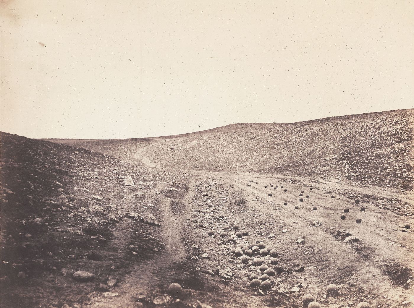 Sepia-toned vintage photograph of a rocky landscape with a winding path.
