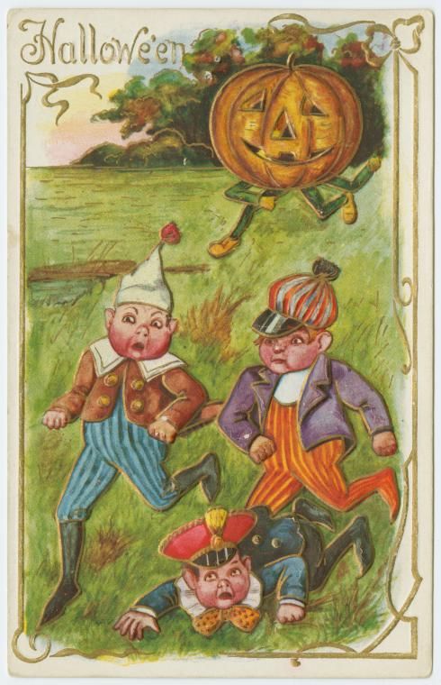 Vintage Halloween postcard with three children tumbling in a field and a floating jack-o'-lantern.