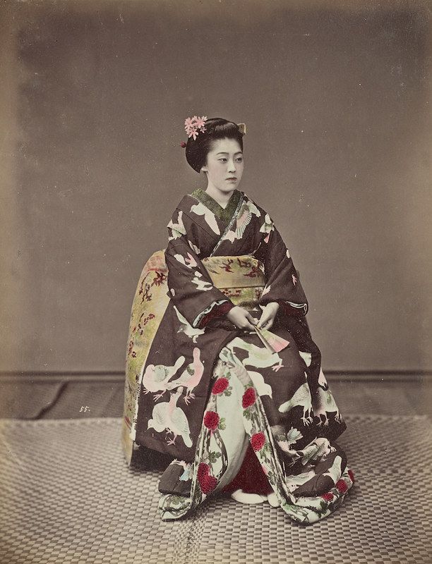 A vintage photograph of a Japanese woman in a kimono.