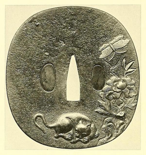 A detailed image of a Japanese tsuba with a cat, dragonfly, and flower.