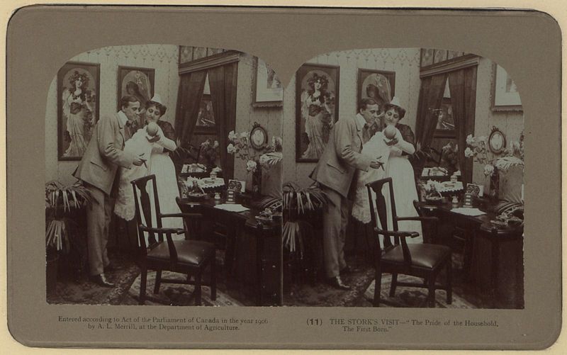Stereoscope card of a Victorian-era interior scene with a man, woman, and child.