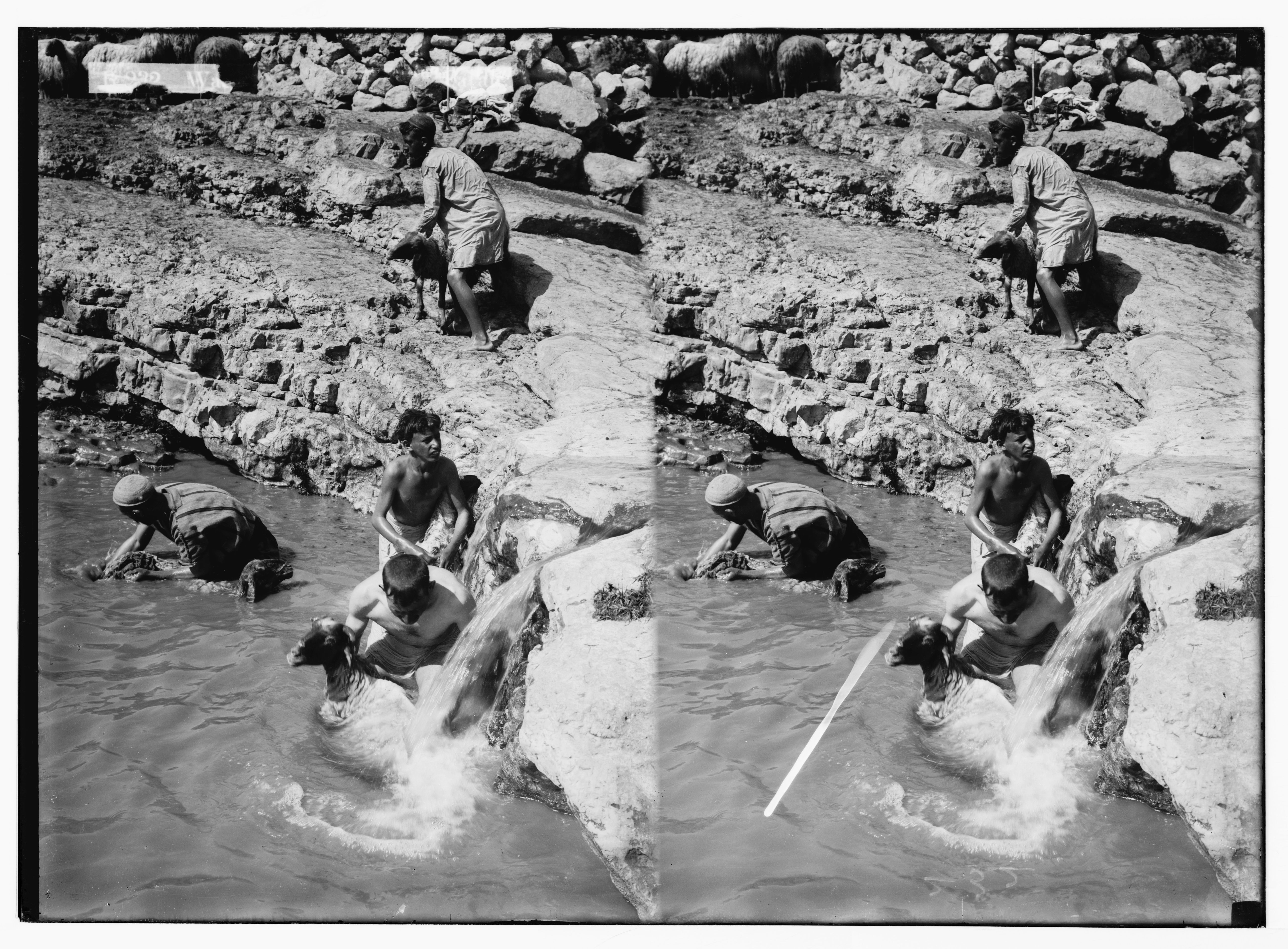 Stereoscopic photograph of a person jumping across a rocky river.