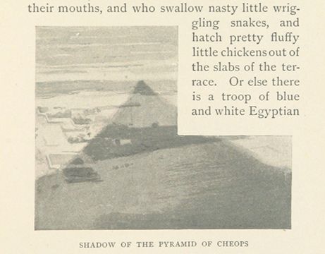 Vintage black and white photograph of the Pyramid of Cheops with a long shadow stretching across a sandy terrain.