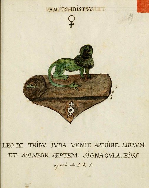 A page from an old book with an illustration of a green ape sitting on a decorated book with a symbol on the cover.