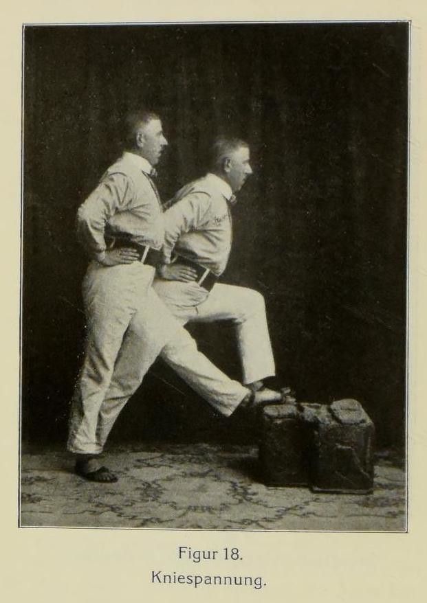 Black and white photograph of two men performing a knee-strengthening exercise.