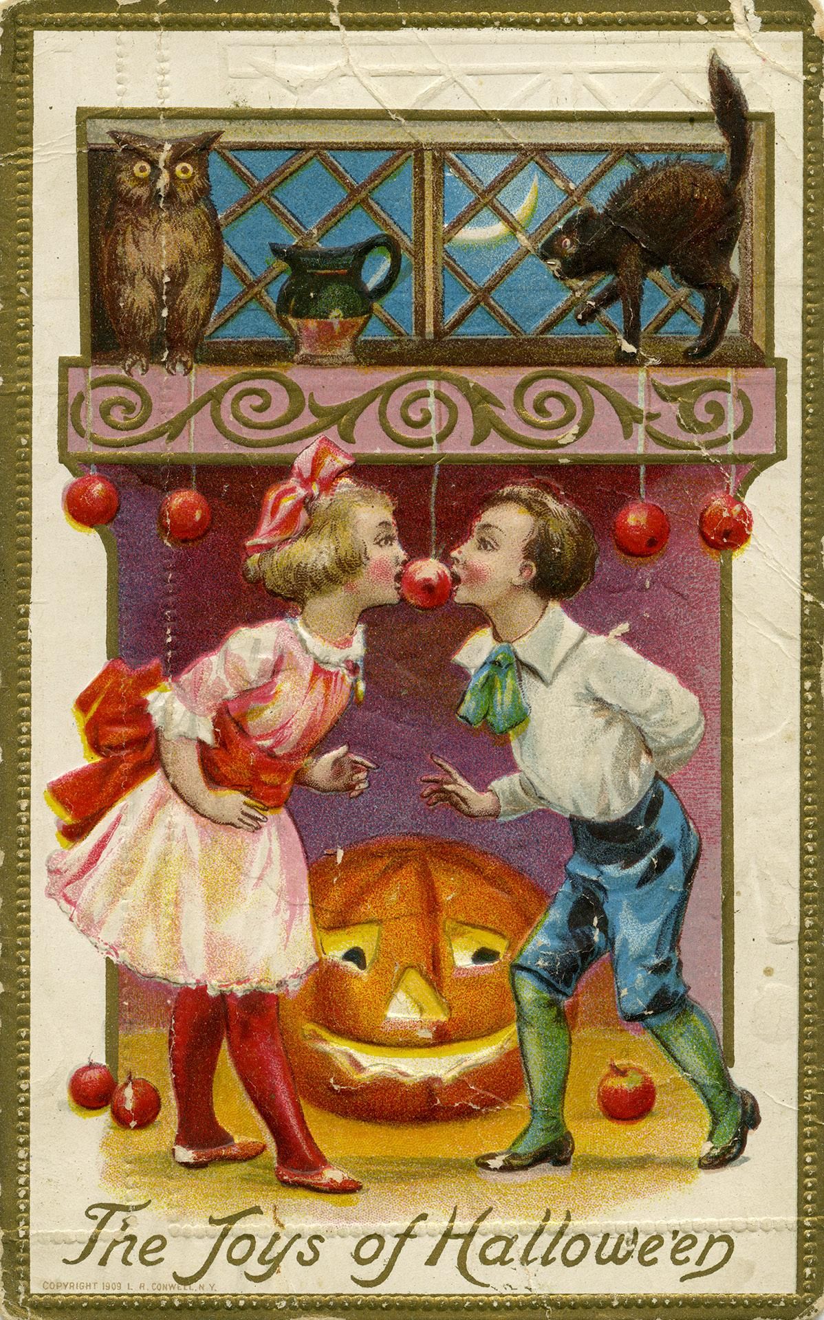 Vintage Halloween postcard illustration of two children about to kiss in front of a jack-o'-lantern.