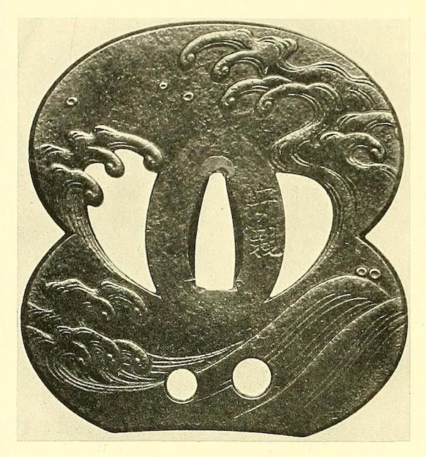 A black and white image of a Japanese tsuba, a sword guard, with carvings of waves and pine trees.