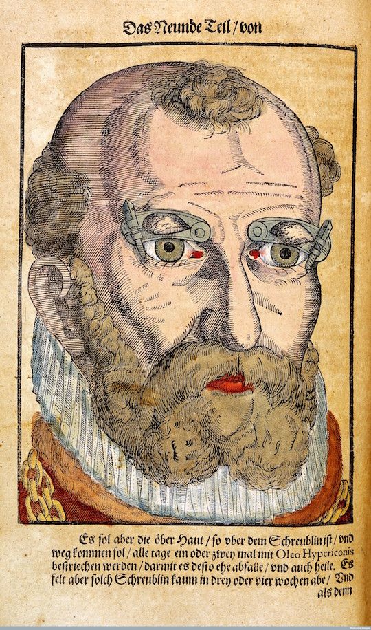 Antique woodcut of an elderly man with glasses and a long beard.