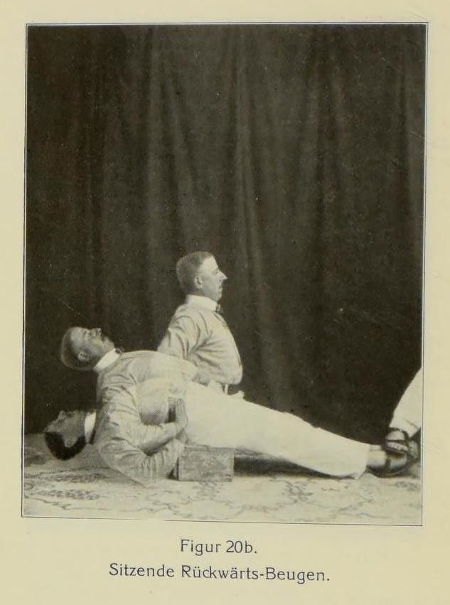 Vintage black and white photograph of three men doing a backbend exercise.
