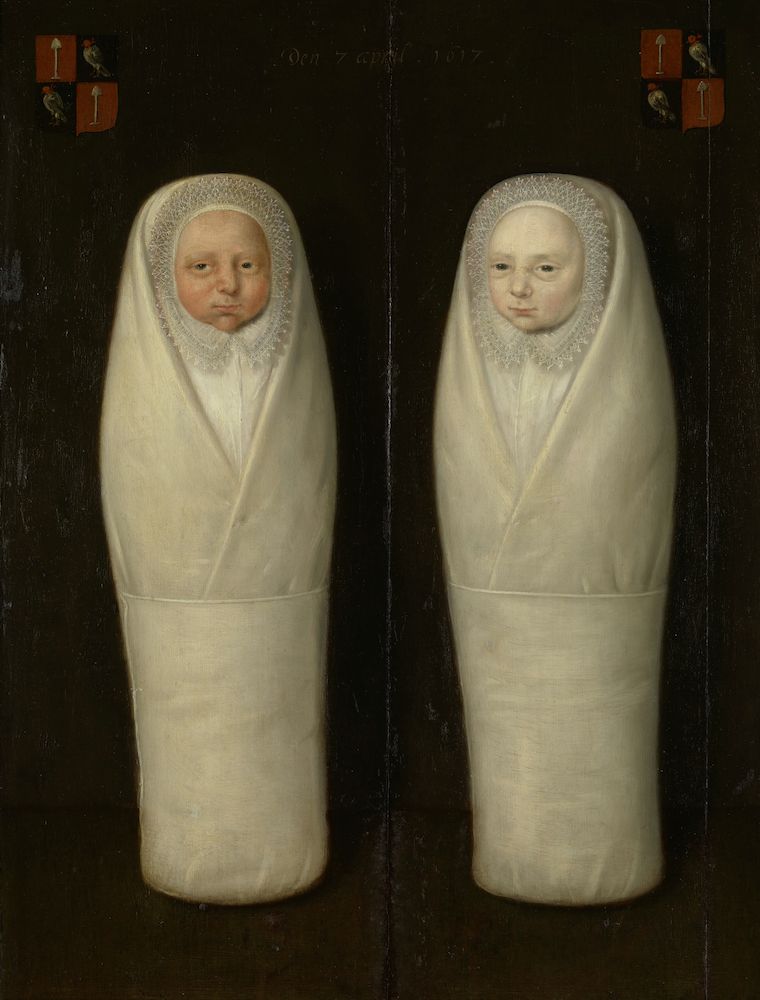 A painting of two babies wrapped in swaddling clothes, with coats of arms above them.