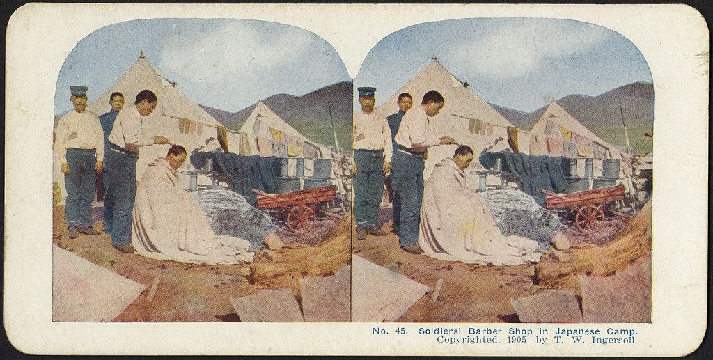 Stereoscopic photograph of a soldiers' barber shop in a Japanese camp, 1906.