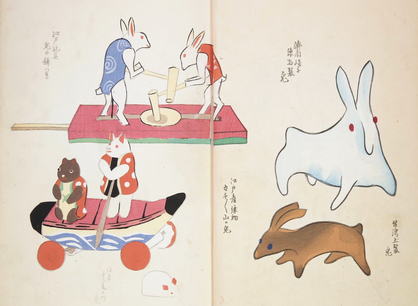 Open book with Japanese illustrations of animals operating machinery and stylized fish and rabbits.