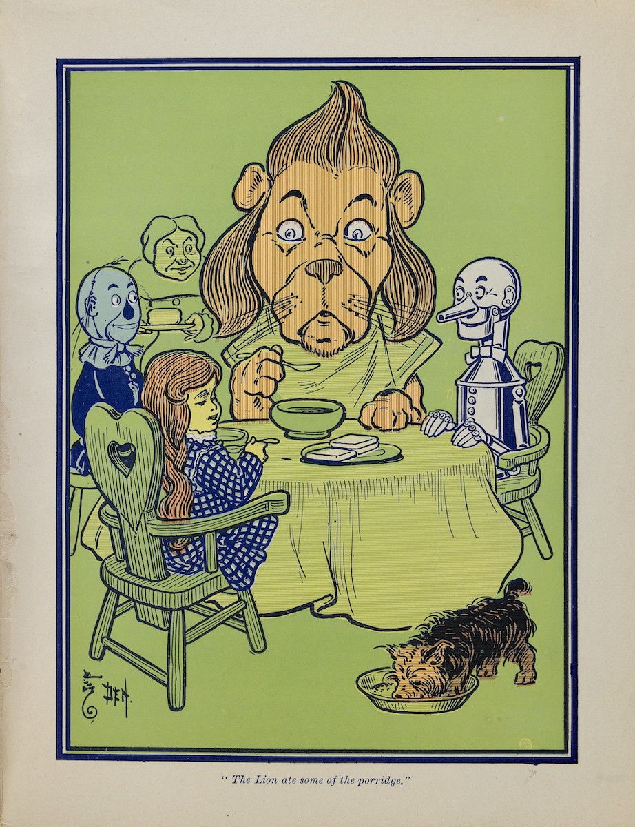 Vintage illustration of the Cowardly Lion, Dorothy, the Scarecrow, and the Tin Woodman at a meal, with Toto looking up at a bowl of porridge.