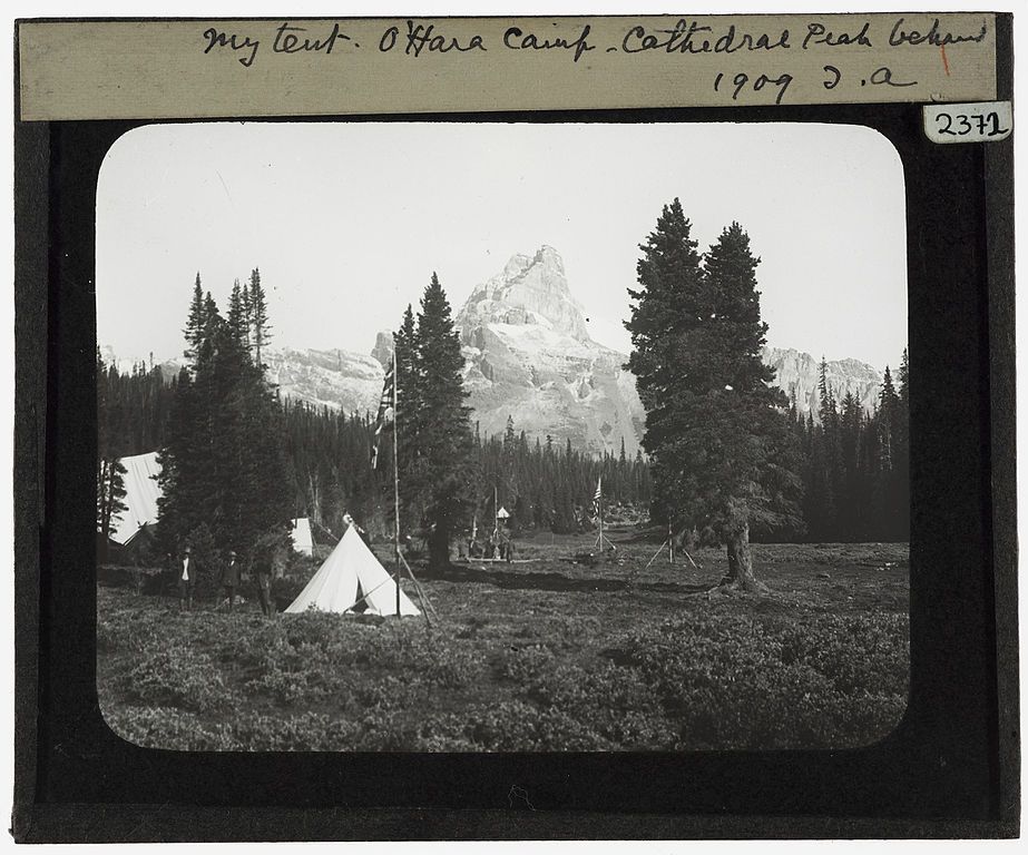Black and white photograph of a tent at O'Hara Camp with Cathedral Peak in the background, taken in 1909.