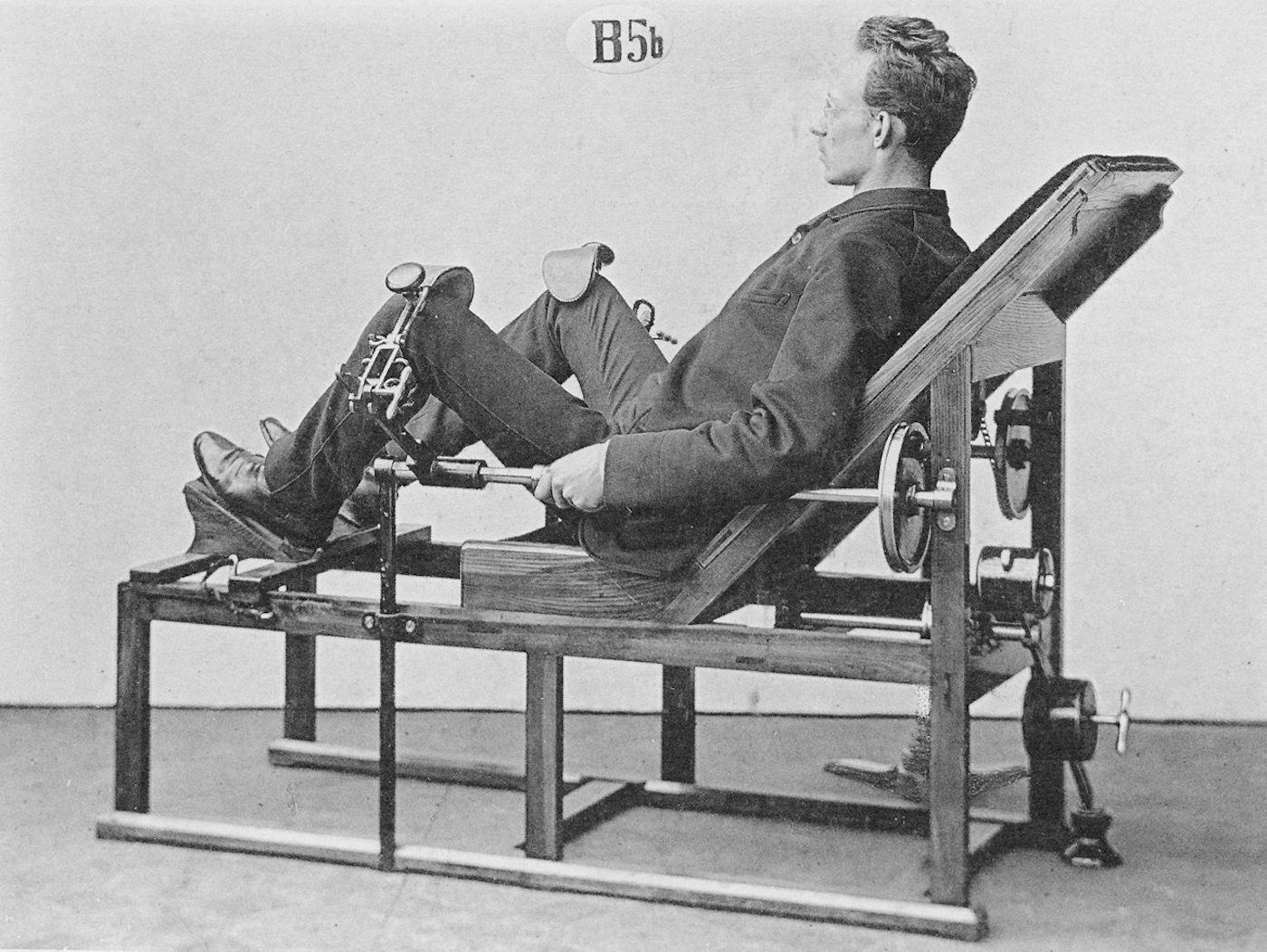Vintage black and white photograph of a man in a medical machine.