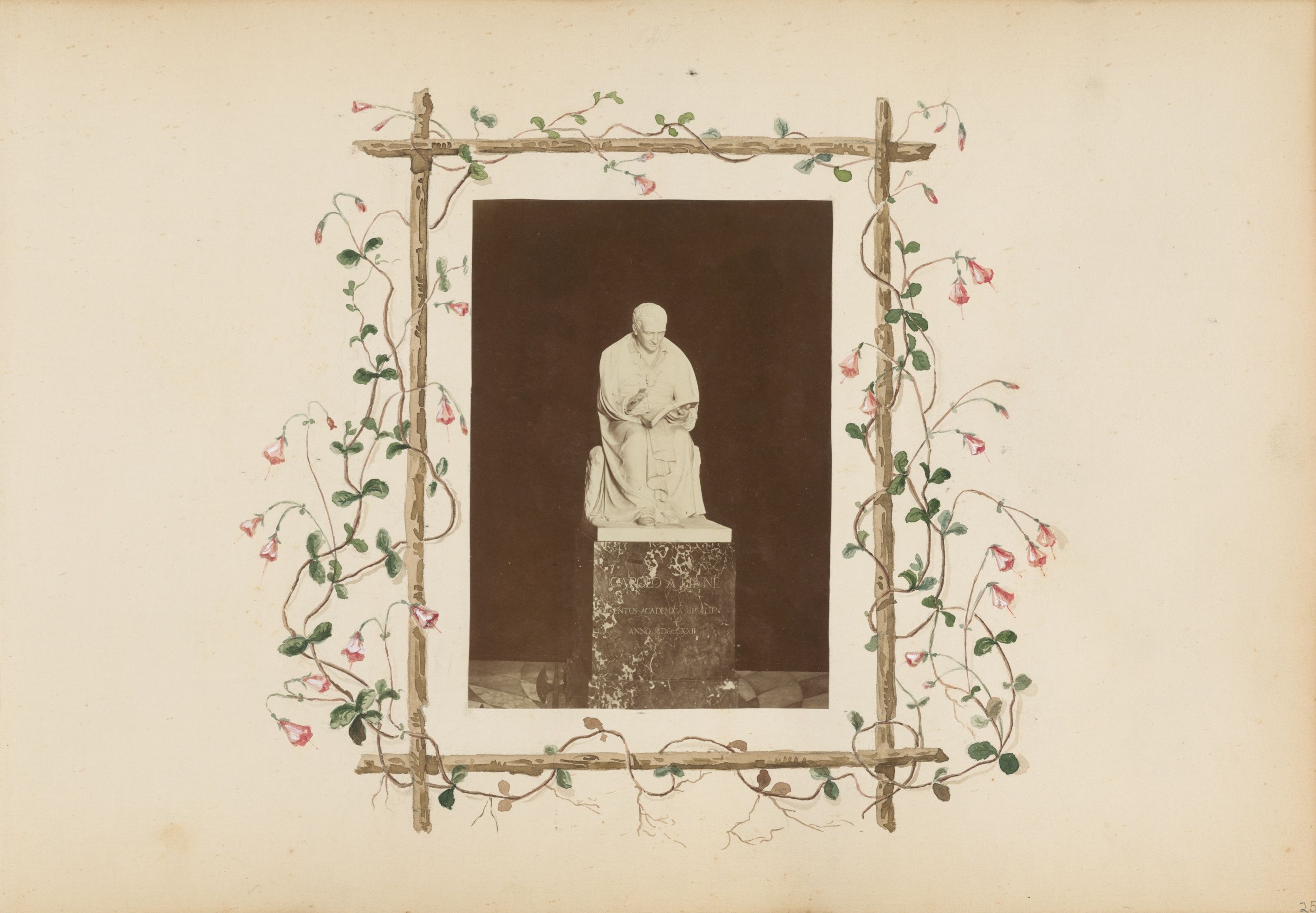 A vintage photograph of a statue on a pedestal, surrounded by a decorative frame of branches and vines with pink and red flowers.