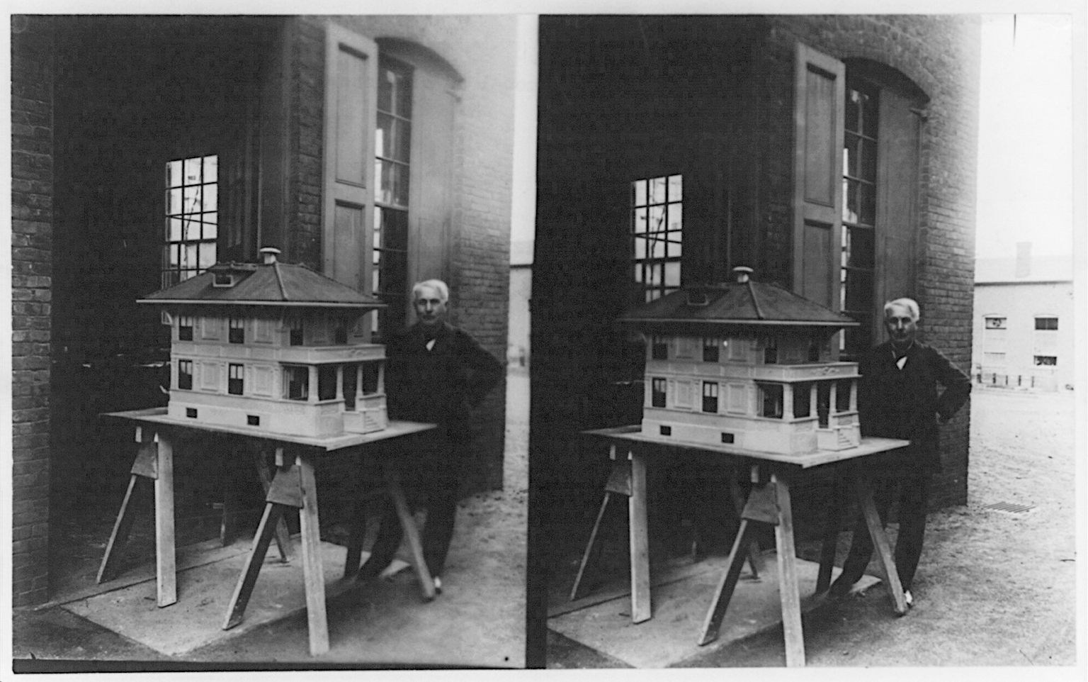 Stereoscopic photograph of a man standing next to a detailed architectural model of a building.
