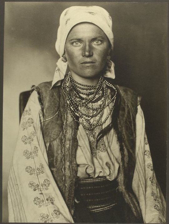 Vintage sepia-toned photograph of a person in traditional attire.