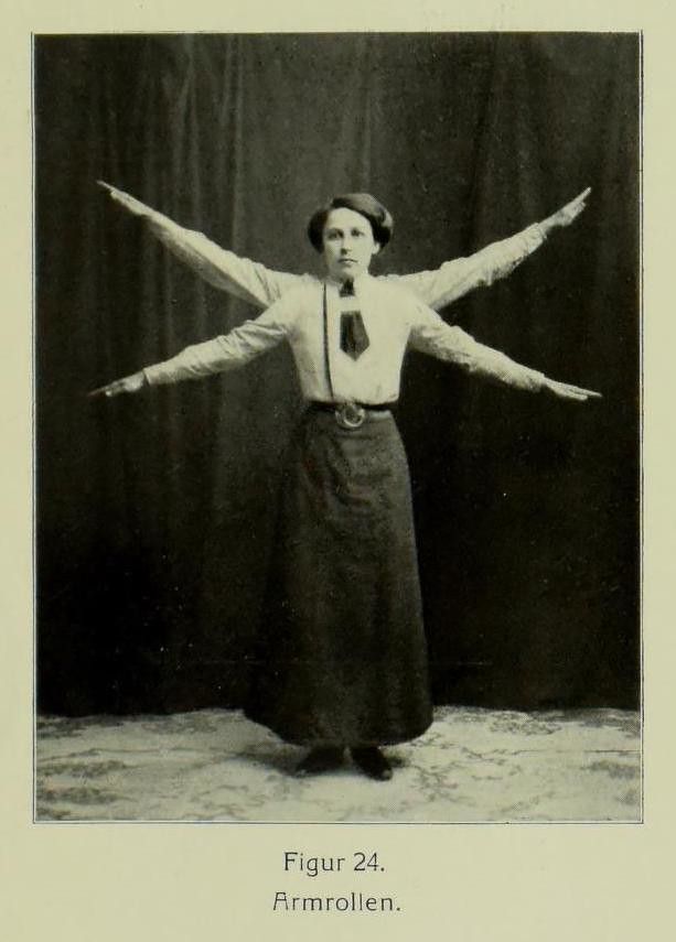 Vintage black and white photograph of a person with arms outstretched in a peculiar pose.