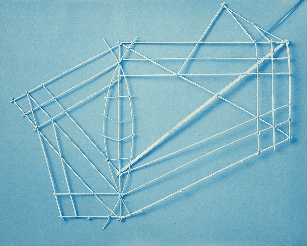 A geometric structure made of toothpicks on a blue background.