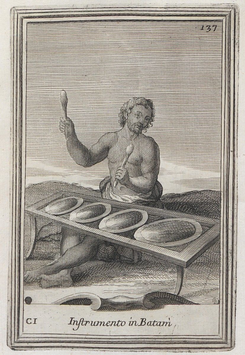A black and white engraving of a man playing a musical instrument consisting of a series of circular dishes on a low table.