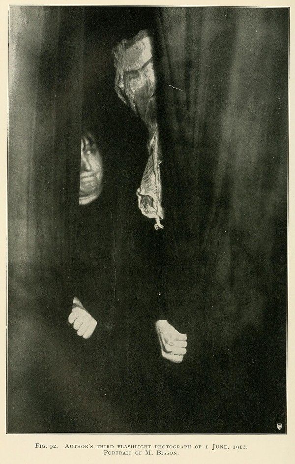 A vintage black and white photograph titled 'Author's Third Flashlight Photograph of 1 June, 1912. Portrait of M. Bisson.' It depicts a person in profile, partially obscured by a sheet or cloth, with their hands raised.