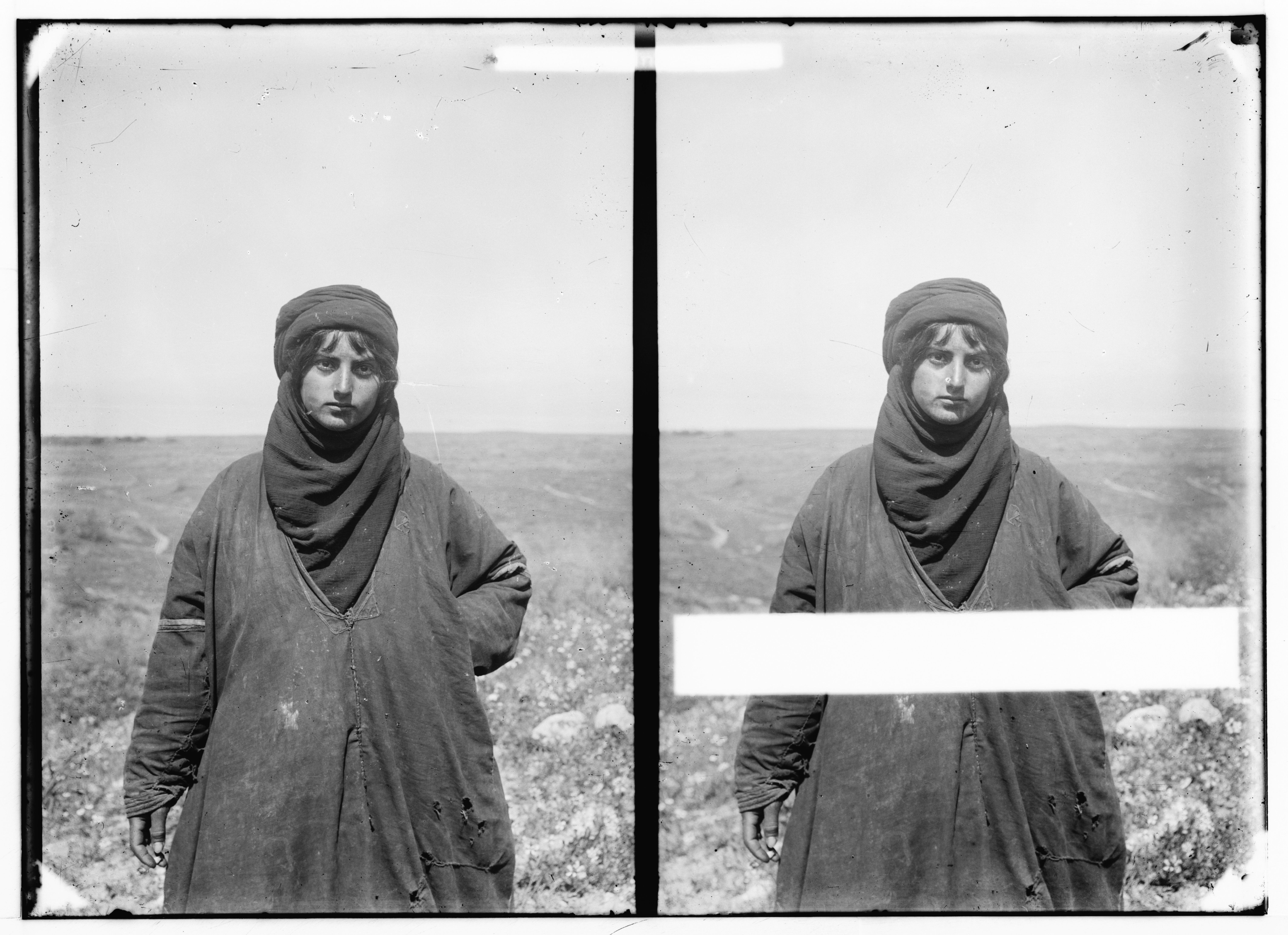 Stereoscopic photograph of a person in traditional clothing standing in a landscape.