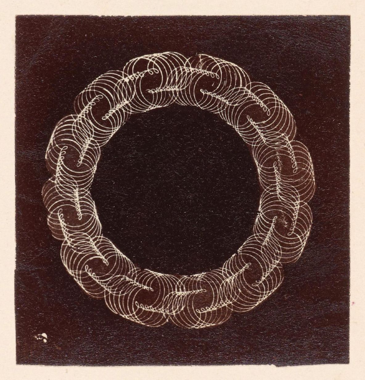 A black and white image of a circular pattern made of swirling lines.