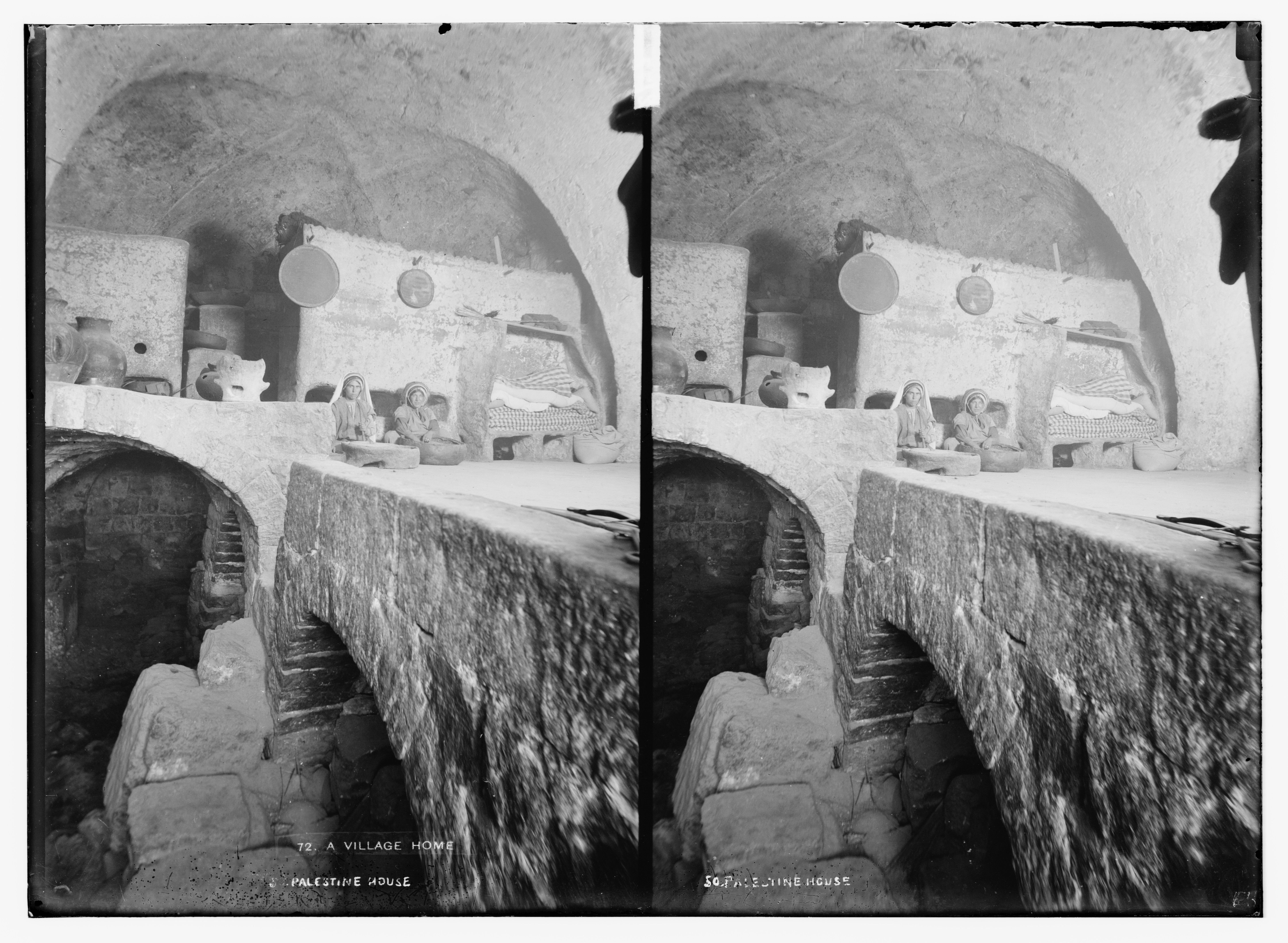 Stereoscopic photograph of the interior of a Palestinian house with people seated along the perimeter of the room.