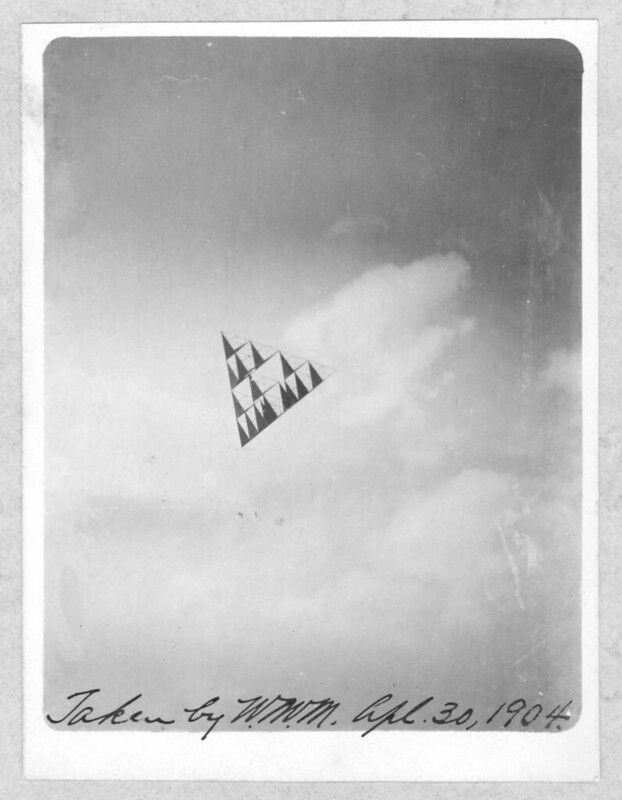 A vintage black and white photograph of a kite soaring in the sky on July 30, 1904.