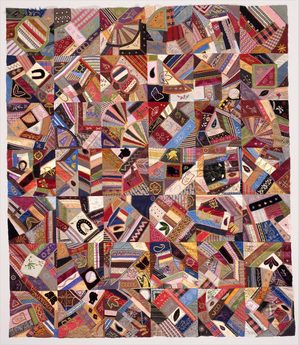 A close-up of a colorful patchwork quilt with various appliquéd motifs.